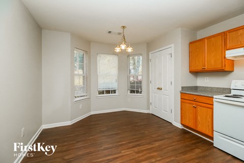 a kitchen and dining room with wood floors and white appliances
