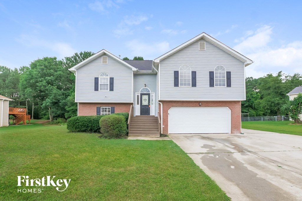 A two-story house with a garage is for sale.