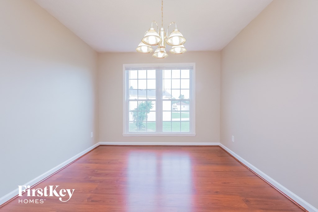 A room with wooden floors and a large window.