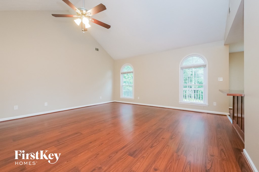 A room with wooden floors and a ceiling fan.
