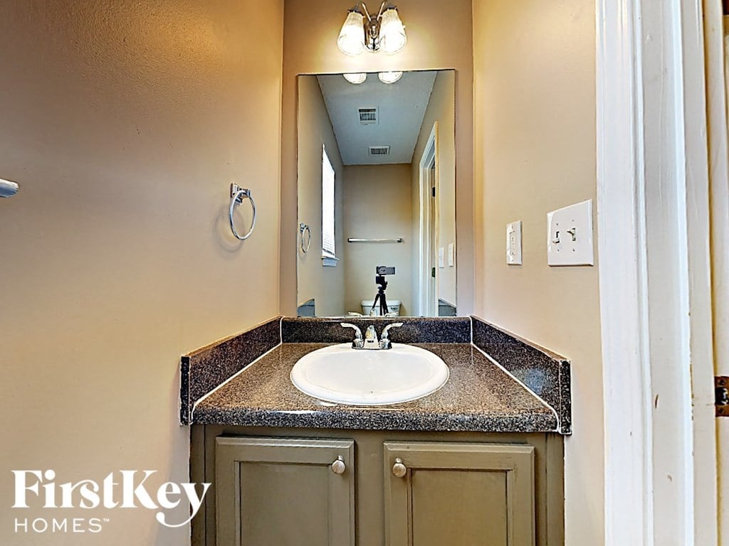 a bathroom with a sink and a mirror
