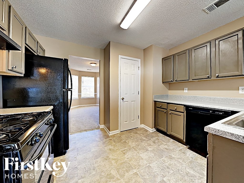 a kitchen with a stove and a refrigerator and a sink