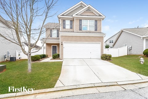 A two-story house with a garage is for sale.
