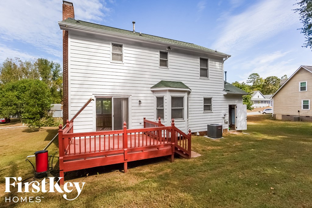 a red porch in front of a white house