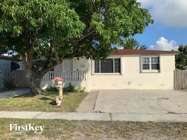 A small house with a tree in front of it.