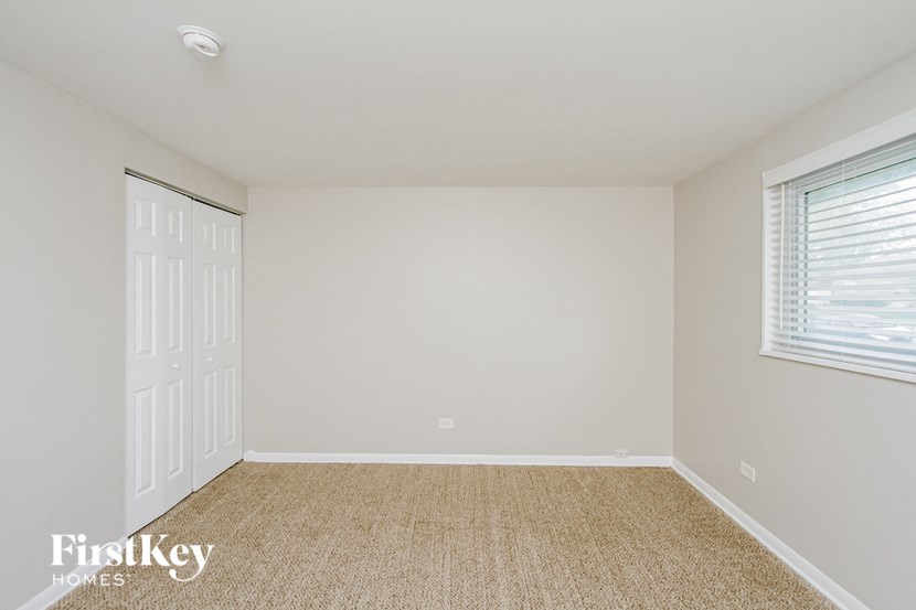 a empty room with a door and a window