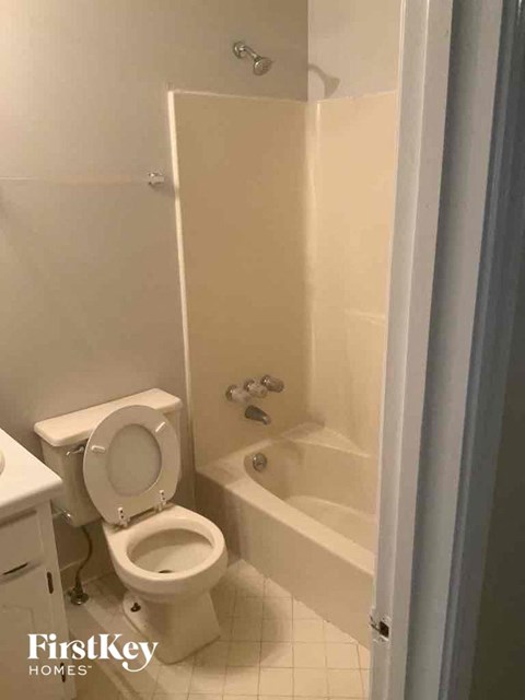 a bathroom with a toilet and a bath tub