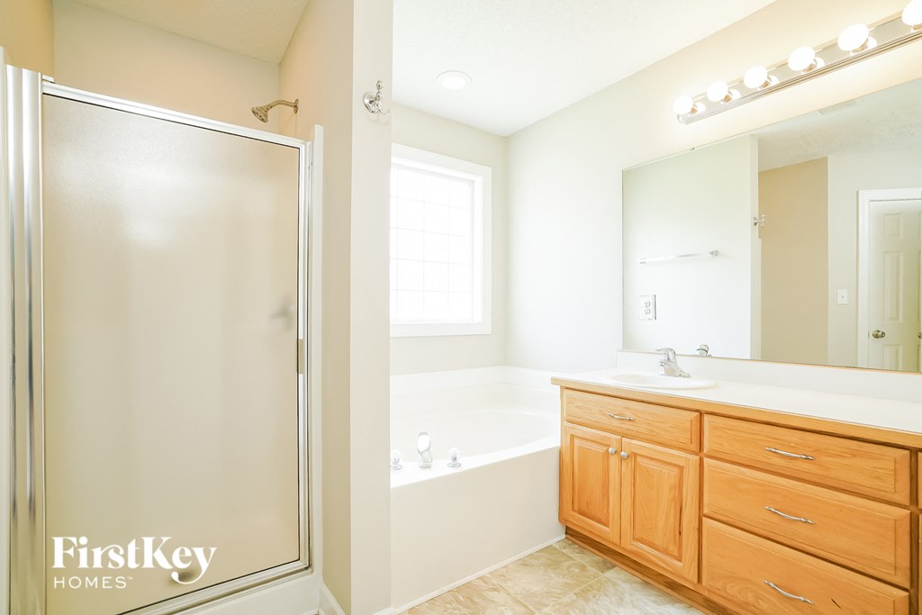 a bathroom with a shower and a sink and a bath tub