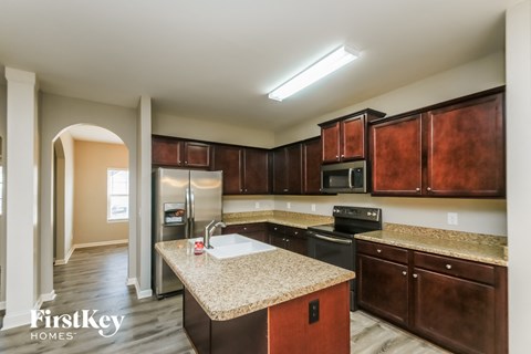 a kitchen with granite counter tops and wooden cabinets