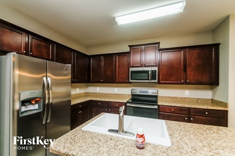 a kitchen with stainless steel appliances and granite counter tops