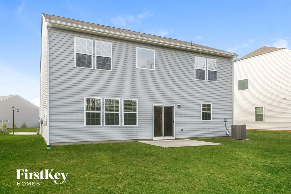 A grey house with a white door and windows is shown.