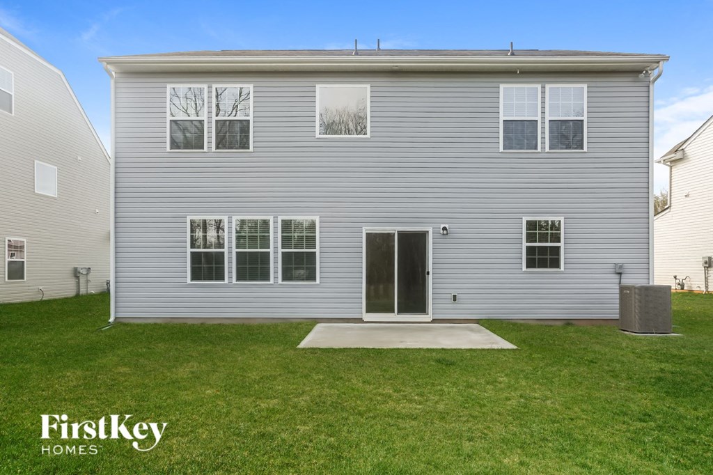 A grey house with a white door and windows is shown.