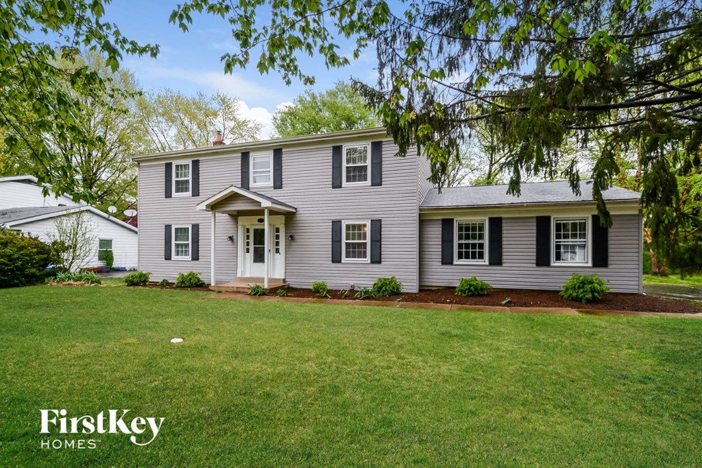 A house with a lawn in front of it.