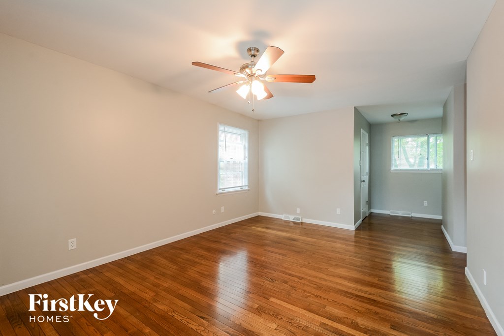 A room with wooden floors and a ceiling fan.