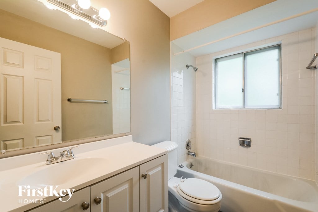 A bathroom with a white sink and a toilet.