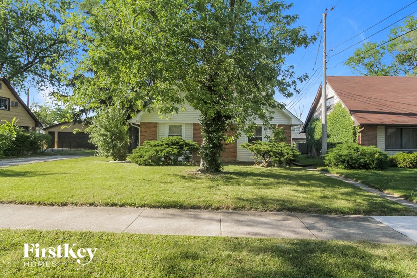 a house with a lawn and a tree in front of it