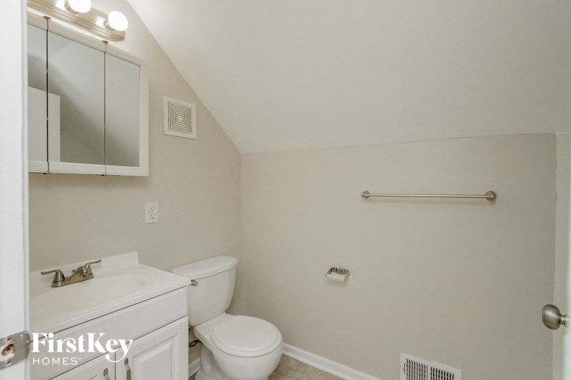 a bathroom with a toilet and a sink and a mirror