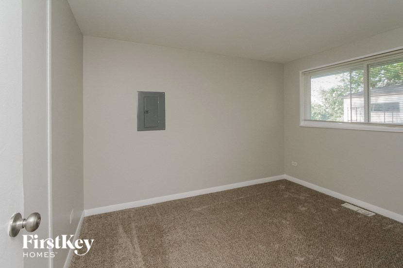 a room with a carpeted floor and a window