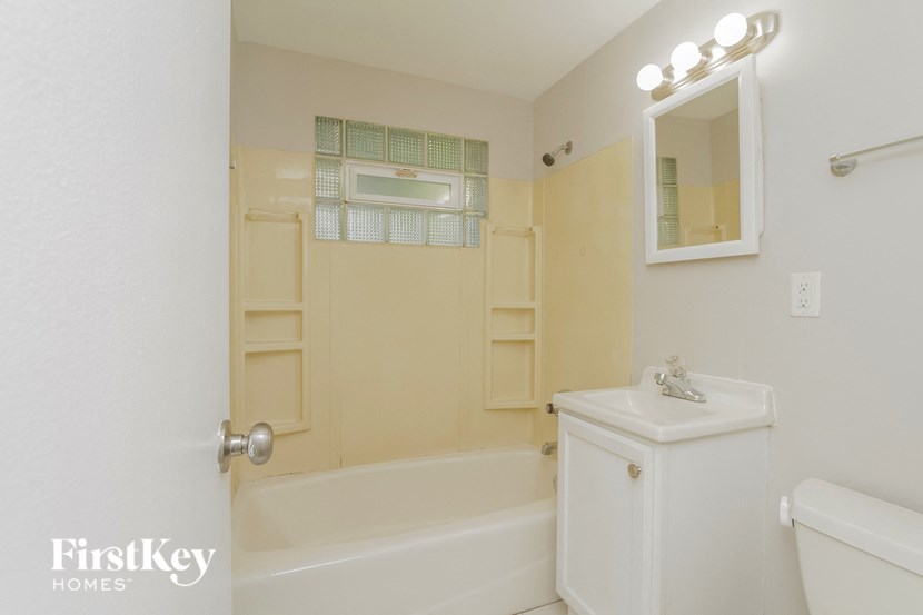 a bathroom with a shower and a sink and a bath tub