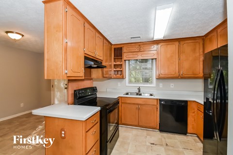 a kitchen with wooden cabinets and black appliances