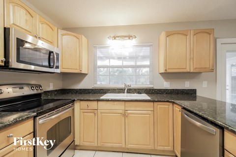 a kitchen with wooden cabinets and granite counter tops