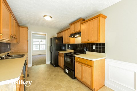 a kitchen with black appliances and wooden cabinets