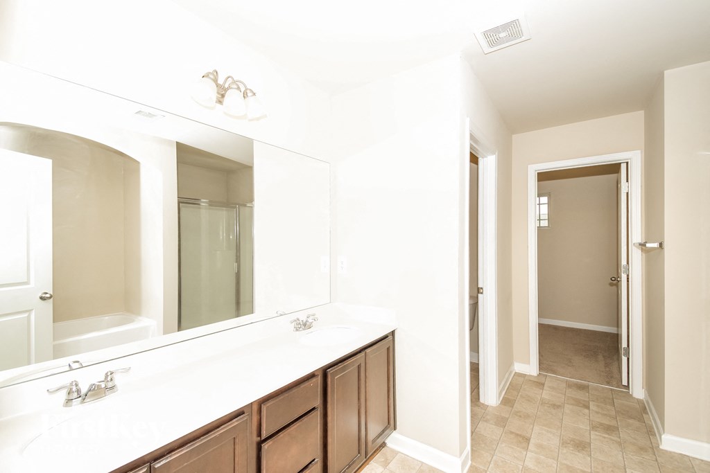 a bathroom with a large mirror and a sink