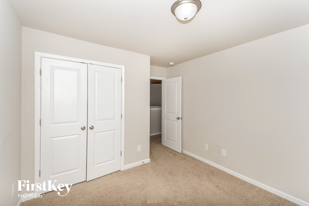 a bedroom with two closets and a door to a bathroom