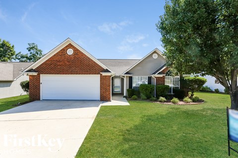 A house with a white garage door is for sale.