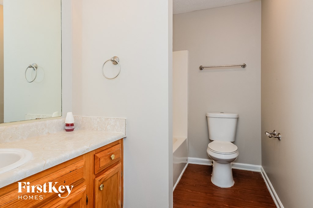 a bathroom with a toilet and a sink and a mirror