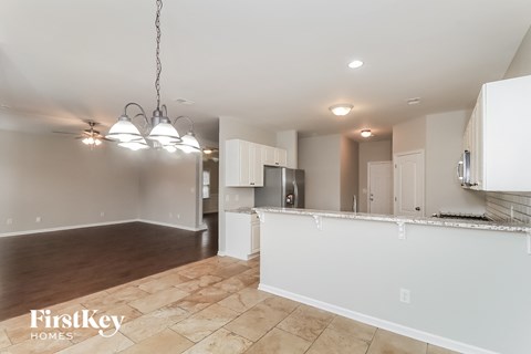 A kitchen area with a countertop and cabinets is shown in a FirstKey Homes property.