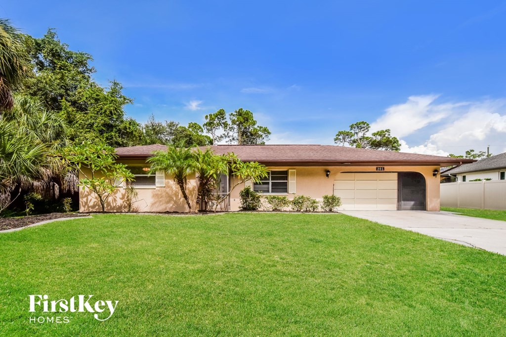a home with a lawn and a garage