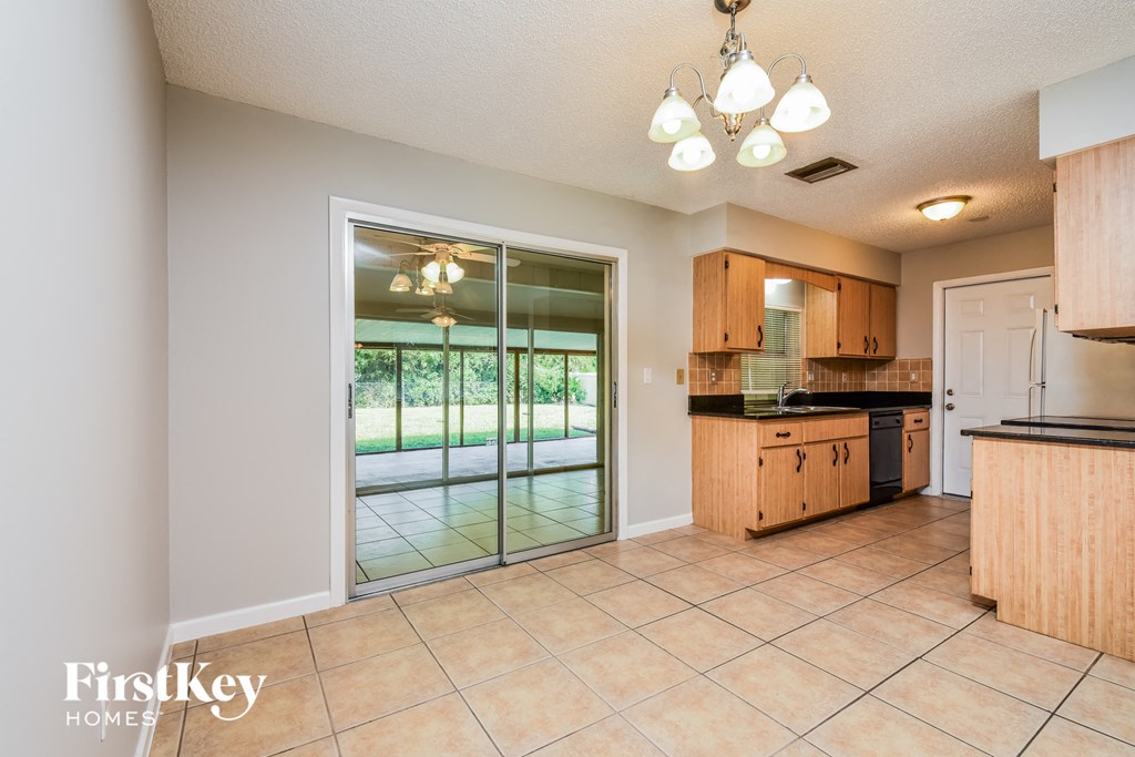 the kitchen is open to the dining room and pool area