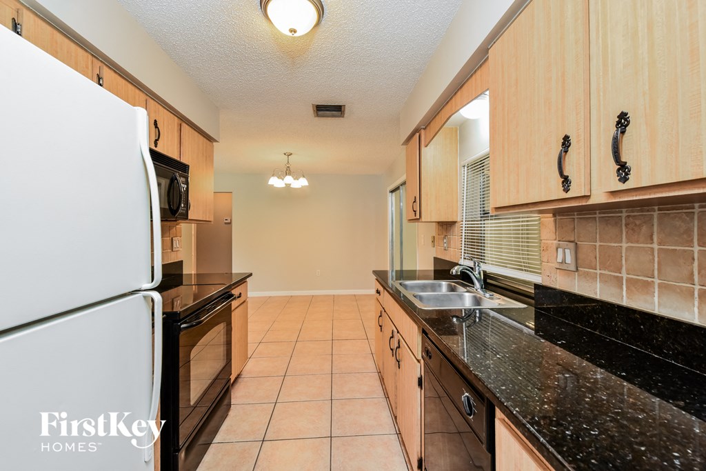 a kitchen with black granite counter tops and a sink