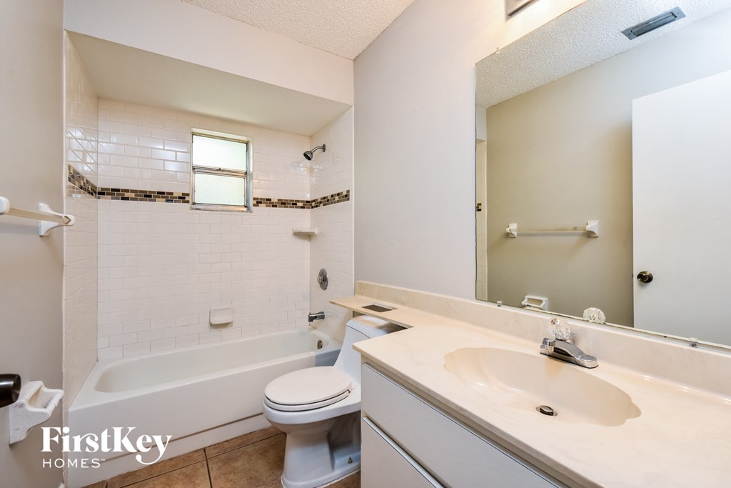 a bathroom with a sink toilet and a bath tub