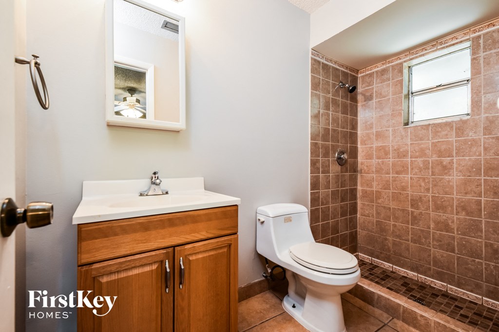 a bathroom with a toilet and a sink and a shower