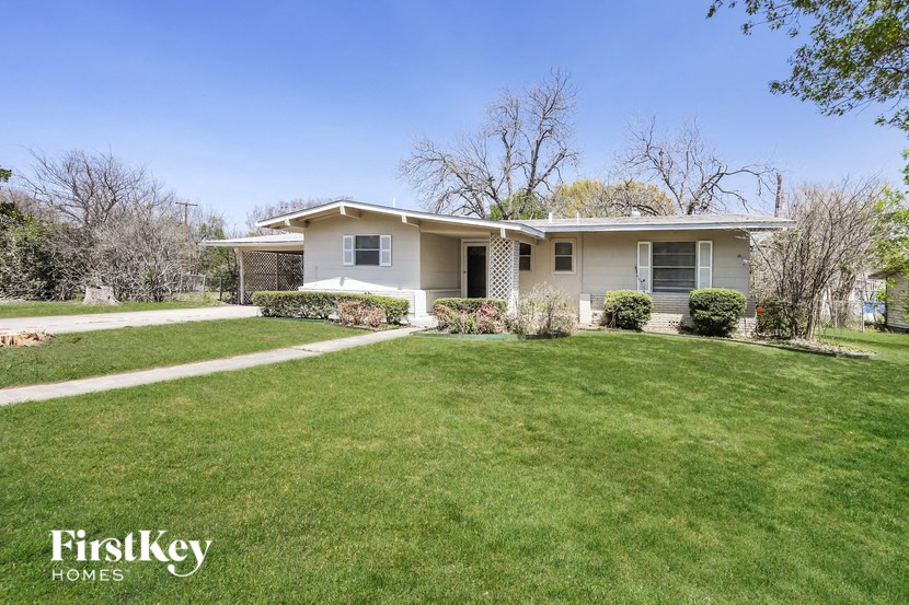 a white house with a lawn and a sidewalk