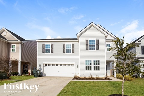 A two-story house with a garage is for sale.