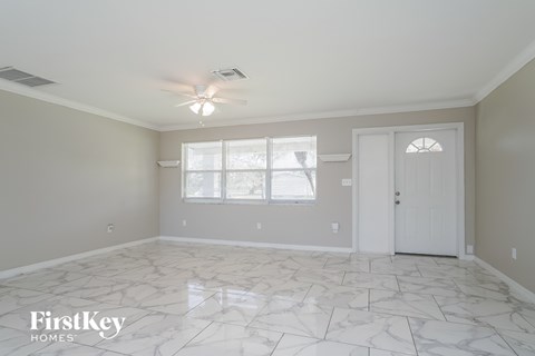 a white and gray room with a white door and a window