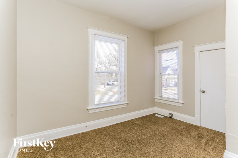 A room with two windows and a door.