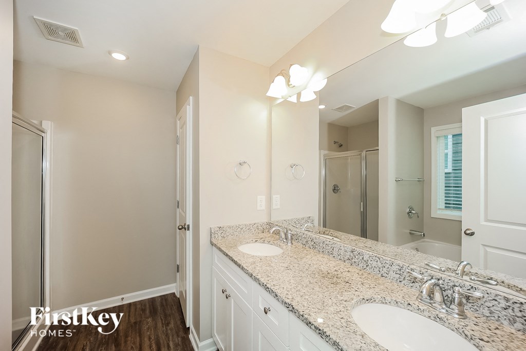 a bathroom with two sinks and a large mirror