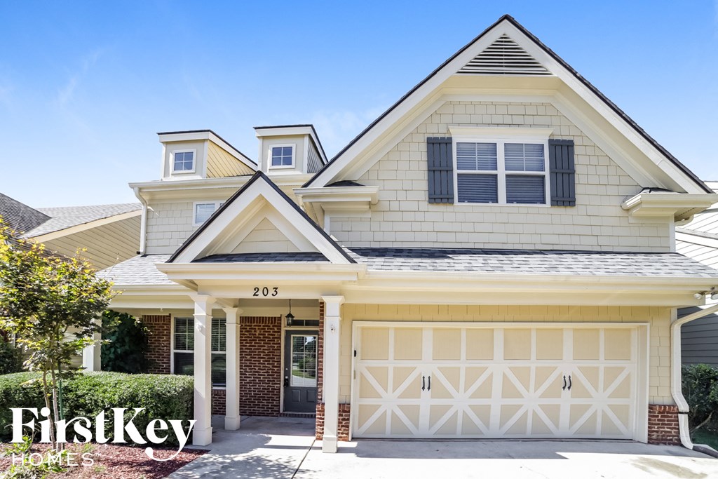a white house with a white garage door