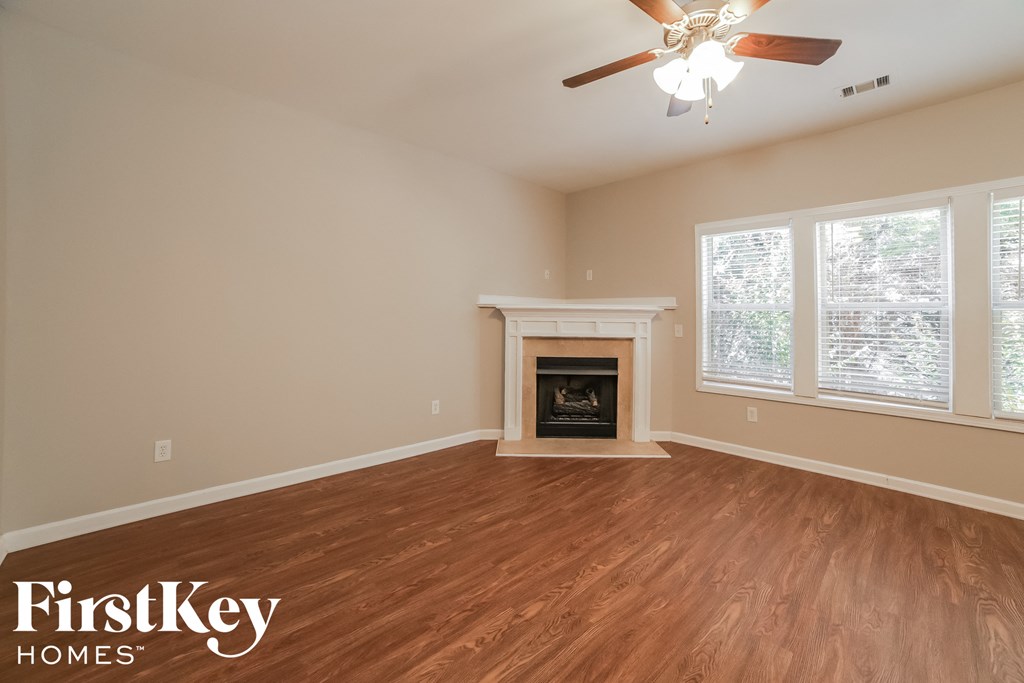 the living room with wood flooring and a fireplace