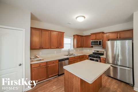 a kitchen with wooden cabinets and stainless steel appliances