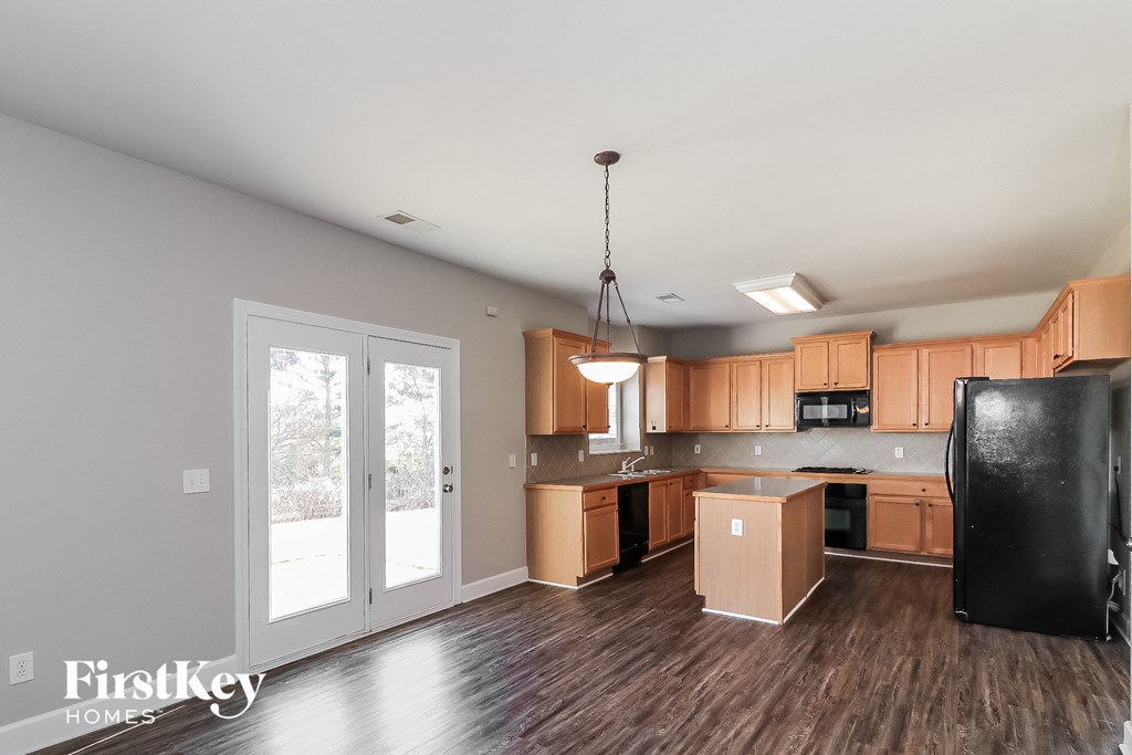 the kitchen is open to the living room and dining room