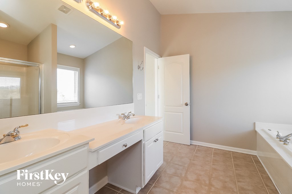 a white bathroom with a sink and a mirror