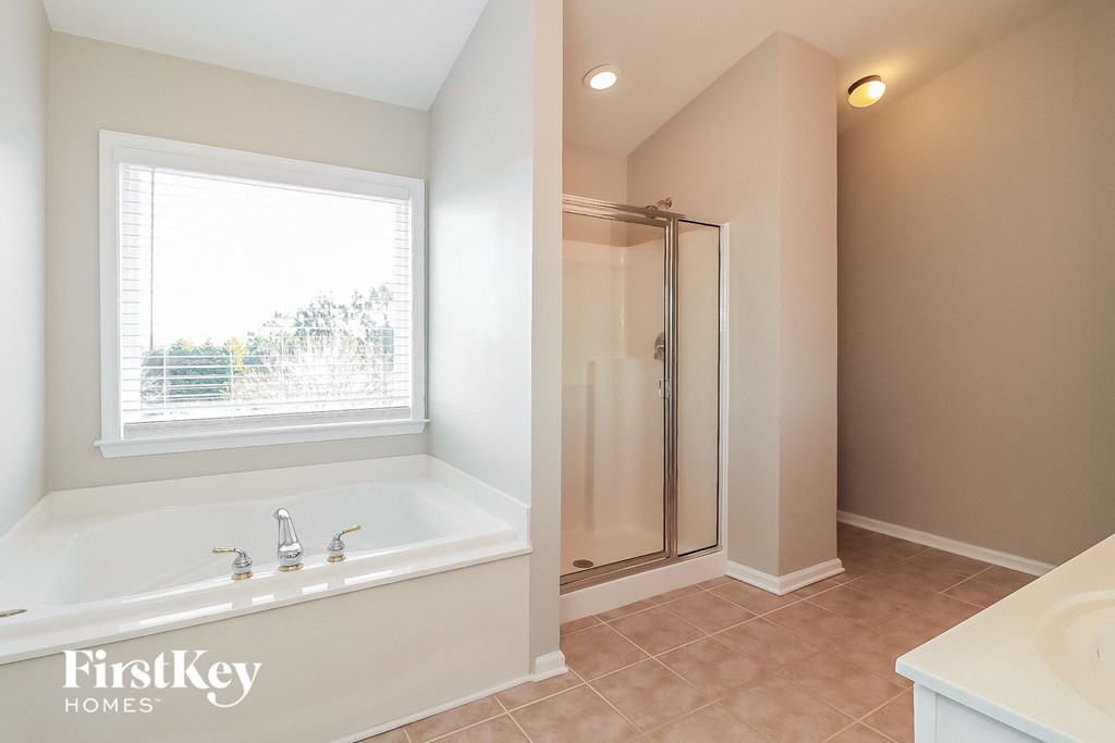 a bathroom with a large tub and a shower