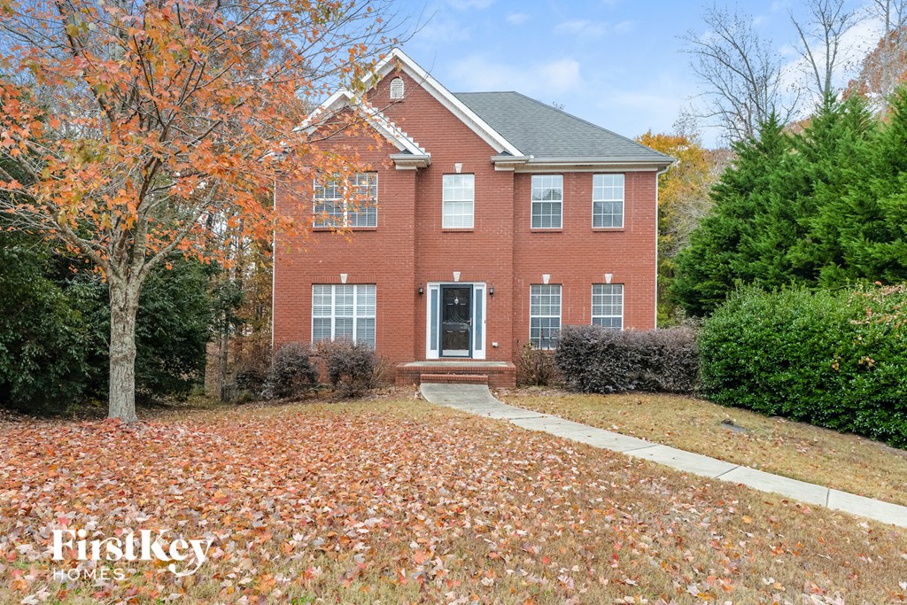 full view of front of house with a yard with fallen leaves