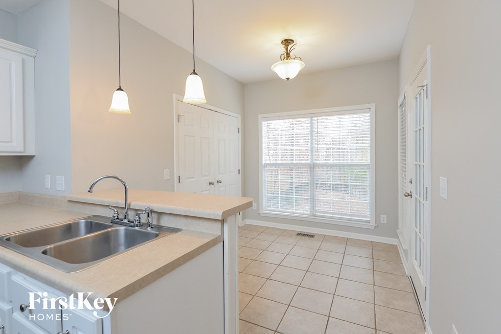 a kitchen with a sink and a window and a door