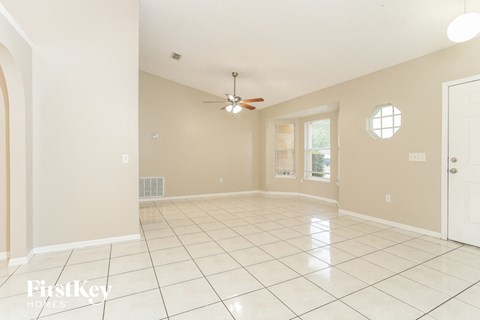 A spacious room with a fan and a window.
